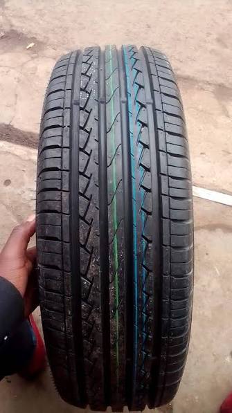 A new passenger tire held up for inspection before fitting.